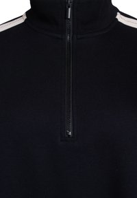 Black zip-up pullover with high collar, featuring a textured material. Notable cream accent stripe along the shoulders. Zipper has a small pull tab.