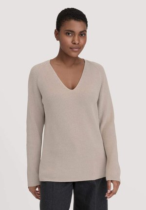 Beige geripptes Strickoberteil mit tiefem V-Ausschnitt, langen Ärmeln und lockerer Passform, ausgestattet mit strukturiertem Gewebe und geradem Saum.