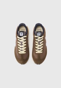 Brown suede and mesh sneakers with cream laces, a white logo on the side, and a padded navy collar. Flat rubber sole with textured tread.