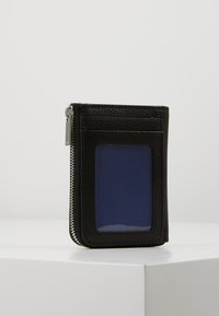 Black leather wallet featuring a transparent ID window, zip closure, and textured finish. Compact design with contrasting interior color.