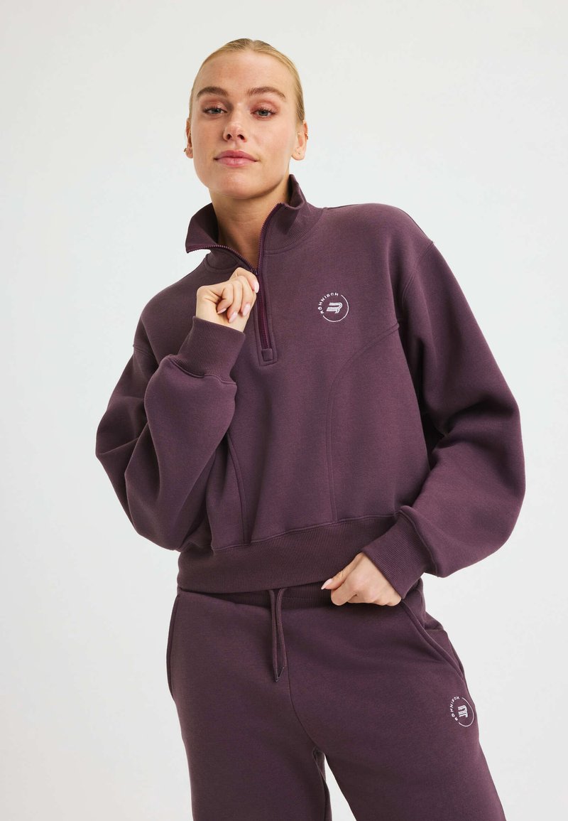 Lila, zip-neck sweatshirt med avslappnad passform, ribbade ärmar och logotypdetalj på bröstet. Mjuk tyg med en slät yta.