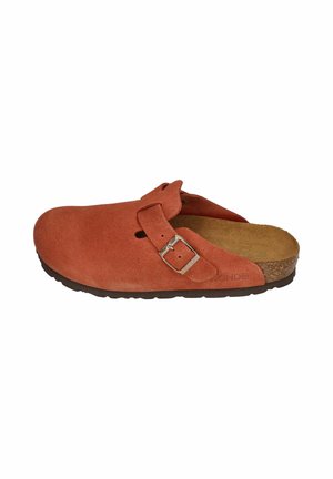 Rust-colored suede slip-on clog with an adjustable strap buckle, cork footbed, and black rubber sole.