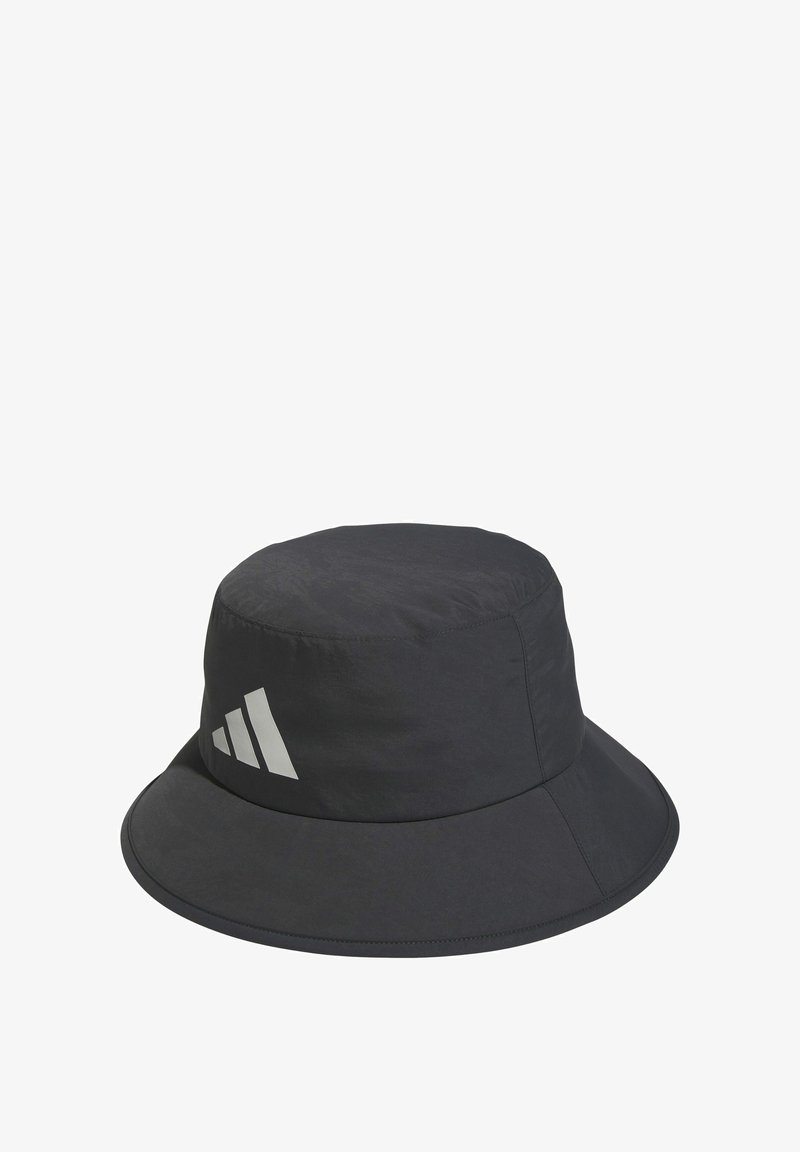Black bucket hat made of lightweight fabric with a smooth texture. Features a wide brim and a reflective three-stripe logo on one side.