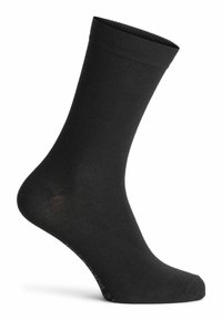 Schwarze Baumwollsocke mit glatter Textur, geripptem Bündchen und verstärktem Fersenbereich. Knöchellang mit einem klaren, schlichten Design und ohne sichtbare Muster.