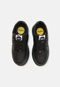 Black leather sneakers featuring a rounded toe, textured accents, a lace-up front, and a yellow logo insole.
