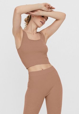 Ribbed, cropped tank top and high-waisted leggings in a muted brown color. The fabric has a soft texture and fitted design.