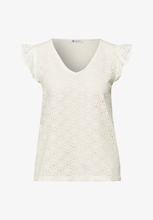 Blouse crème à manches courtes avec col en V et motif en dentelle à œillets, dotée de petites manches flottantes et d'un tissu léger.