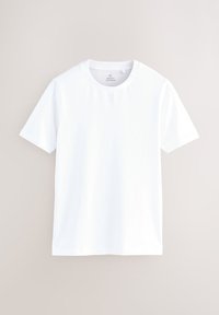 T-shirt blanc uni à manches courtes et col rond présenté sur un fond clair et neutre.