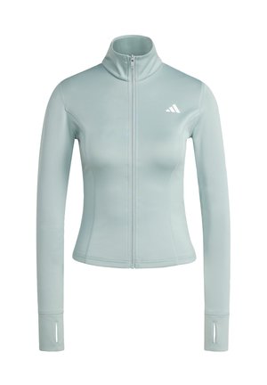 Veste ajustée bleu clair avec fermeture éclair, manches longues, passe-pouces et petit logo blanc sur la poitrine gauche.