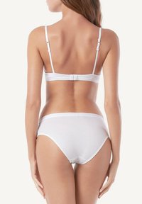 Biały komplet biustonosza i majtek z bawełny, z regulowanymi ramiączkami, bezszwowym krojem i miękkim pasem. Prosty, minimalistyczny styl.