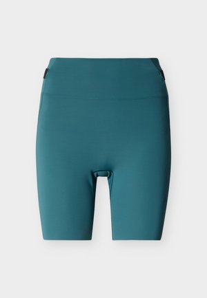 Sykkelshorts i blågrønn, laget av glatt og elastisk stoff. Har en høy midje og et minimalistisk design uten synlige sømmer eller beslag.