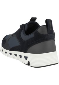 Sneaker blu navy realizzato con un mix di suede e materiali sintetici, suola in gomma testurizzata e intersuola bianca a contrasto con fori circolari.