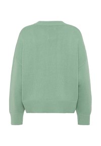 Pull en maille vert menthe, au design oversize, avec des poignets et un ourlet côtelés, un col rond, et un tissu texturé agrémenté de détails de couture subtils.