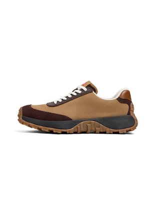 Sneaker featuring a tan textile upper, dark brown suede accents, white laces, and a black and tan patterned rubber sole.