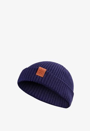 Navy ribbed knit beanie made of wool with a folded cuff. Features a square leather patch with embossed logo on the front.