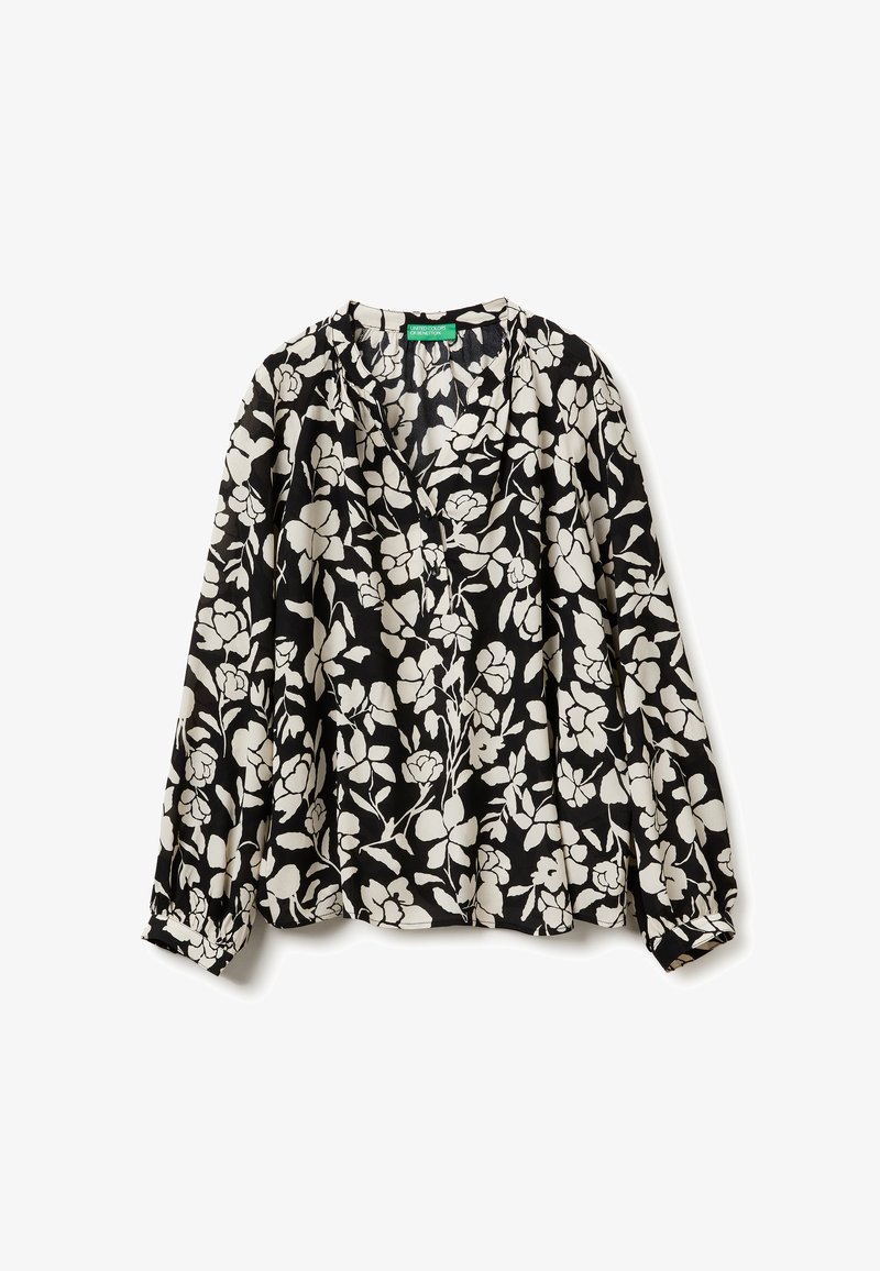 Schwarz blouse mit weißem Blumenmuster, langen Ärmeln mit gerafften Bündchen und einem V-Ausschnitt. Hergestellt aus leichtem Stoff.