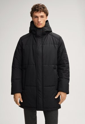 Black puffer coat with a high collar and hood, featuring horizontal quilted sections and side pockets, made from a smooth, water-resistant material.