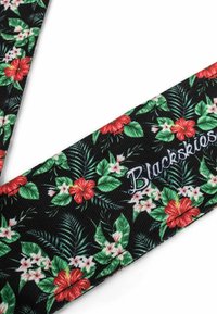 Floral strap featuring a black background with red hibiscus flowers and green leaves. Text "Blackskies" in white embroidery. Textured fabric.