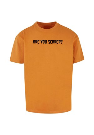 Orange cotton t-shirt featuring black print text "ARE YOU SCARED?" in a jagged font. Short sleeves, crew neck, and relaxed fit.