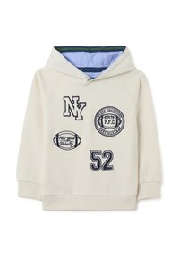 Sweat à capuche en écru avec des écussons brodés bleu marine, comprenant "NY", "52", et des motifs liés au sport. Tissu doux avec des poignets côtelés.