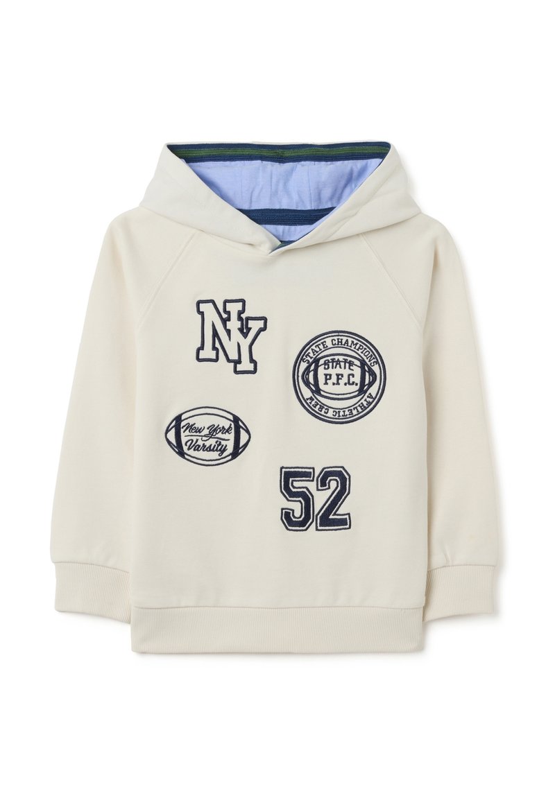 Sweat à capuche en écru avec des écussons brodés bleu marine, comprenant "NY", "52", et des motifs liés au sport. Tissu doux avec des poignets côtelés.