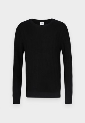 Črn pulover z rebrasto teksturo, dolgimi rokavi in okroglim vratom. Ponaša se s tesnim prileganjem in čistim dizajnom. Logo blagovne znamke na vratu.