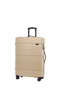 Valigia rigida beige con scanalature orizzontali, manico telescopico nero e quattro ruote nere per una facile manovrabilità. Include un manico laterale.