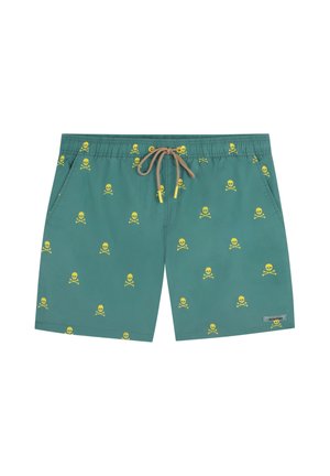 Bañador corto azul verdoso con estampado amarillo de calaveras y huesos cruzados, cordón marrón, bolsillos laterales y pequeña etiqueta rectangular con logo en la parte frontal de la pierna derecha.