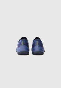 Navy athletic shoes with a textured upper, rounded heel, and rubber outsole featuring a detailed tread pattern for traction.