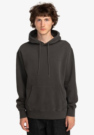 Dark gray pullover hoodie with a front pocket, drawstring hood, and subtle branding; made of soft, textured fabric.