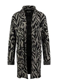 Cardigan lungo nero e beige con un motivo astratto a zigzag, apertura frontale, due tasche anteriori e tessuto strutturato.