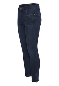 Temno modri kavbojke skinny kroja z gladko teksturo, petimi žepi in zadrgama na gležnjih. Imajo pas srednje višine.