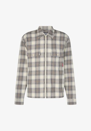 Koszula w kratę flanelowa w kremowych, brązowych i szarych odcieniach. Posiada zamek z przodu, dwie kieszenie na piersi oraz miękką teksturę z wytrzymałym kołnierzem.