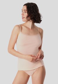 Light pink camisole with thin straps and lace trim at the neckline, made from soft, smooth fabric, paired with matching bikini bottoms.