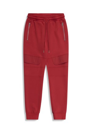 Rode joggingbroek met elastische tailleband, trekkoorden, zijzakken met rits, klepzakken op de dijen en omgeslagen enkels.