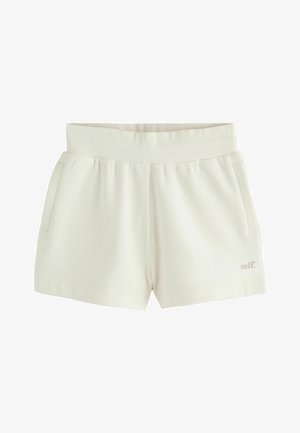 Casual shorts i cremefarve med ribbet elastisk linning, sidelommer og lille "self" broderi på venstre ben nederst.
