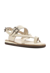 Beige leren sandalen met kruiskruisbandjes, verstelbare gespen en een platte zool. De binnenzool is zacht en het ontwerp heeft een lichte hak.