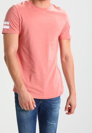 Light coral short-sleeve t-shirt made of cotton; features two white stripes on the shoulders and a classic crew neck design.