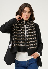 Sciarpa nera e beige con un motivo a zigzag, realizzata in morbido tessuto, con un bordo a costine su entrambi i lati.