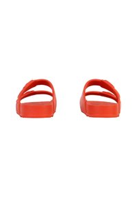 Red rubber sandals with a flat sole and three prominent strap sections. Smooth texture and open back design, suitable for casual wear.