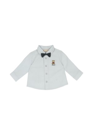 Chemise blanche à manches longues pour tout-petit avec boutons, petite broderie d'ourson sur la poitrine et nœud papillon noir attaché.