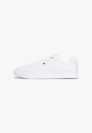 White canvas sneakers featuring a smooth texture, round toe, flat sole, and subtle logo detail on the side. Classic lace-up design.