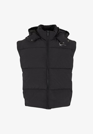 Melnā pūkainā veste ar rāvējslēdzēju priekšpusē, kapuci un pogām. Ar kvadrātveida tekstūru un diskrētu zīmola logo uz pleca.