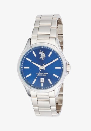 Orologio da polso in metallo argentato con quadrante blu, indici bianchi, datario alle 6 e logo U.S. Polo Assn. alle 12.
