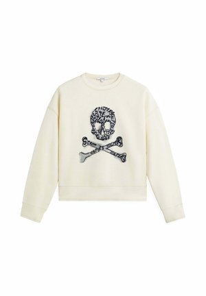 Sudadera color crema con un diseño cropped, que presenta un gráfico bordado de calavera y tibias en el centro. Textura de tela suave.