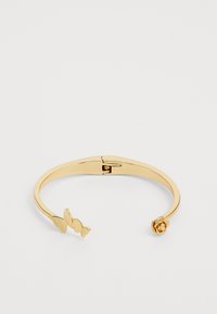 Gold metal cuff bracelet featuring three butterfly accents on one end and a rose detail on the other, polished smooth surface, open design.