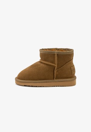 Brown suede ankle boots with a soft, fluffy lining, featuring a stitched seam and a textured rubber sole. Low-cut design for easy wear.