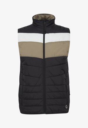 Must must vest, millebeige ja valgete horisontaalsete triipudega, kõrge kaelusega, esi tõmblukuga ja kahe küljetaskuga. Omab õmblustekstiuri.