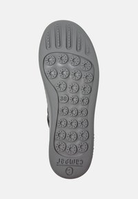 Grijze schoenzool met afgeronde noppen voor grip, met maat 38 duidelijk afgebeeld. Het ontwerp suggereert casual, comfortabele schoenen.