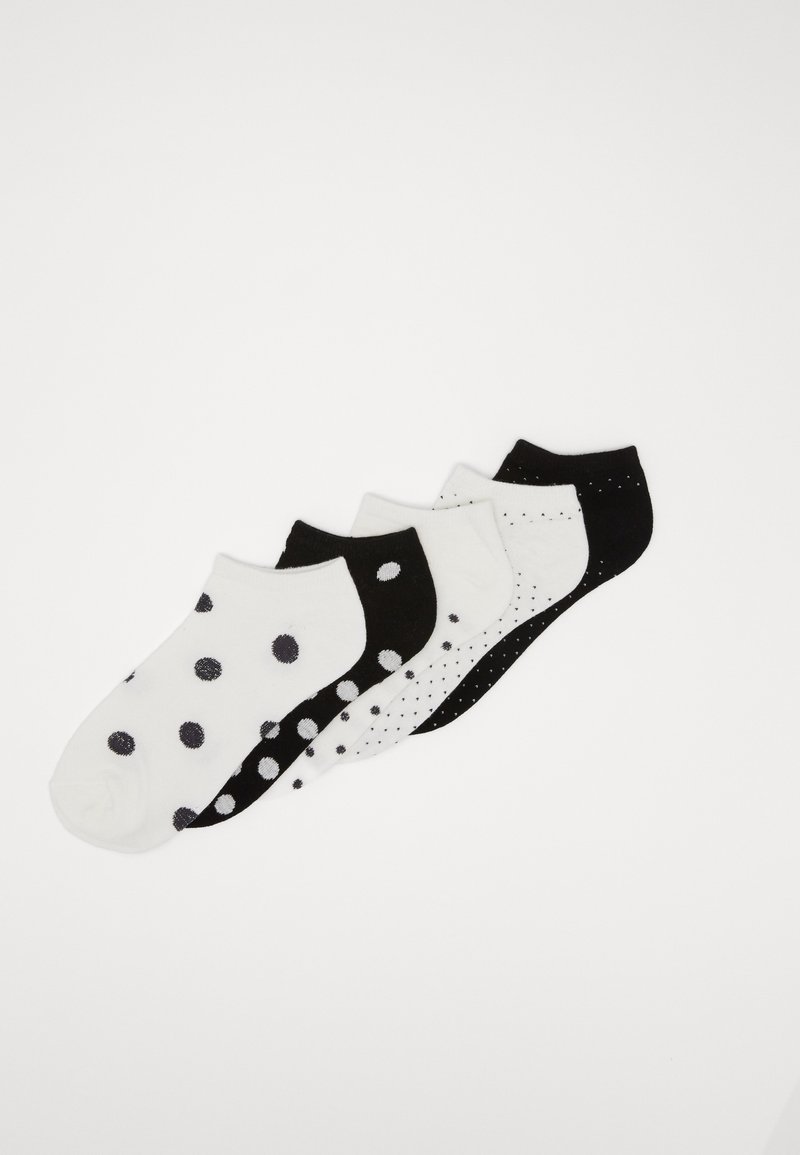 Fem par ankelsockor i svart och vitt. Ett par har stora prickar, medan de andra har mindre prickar och en enfärgad design. Mjukt bomullsmaterial.